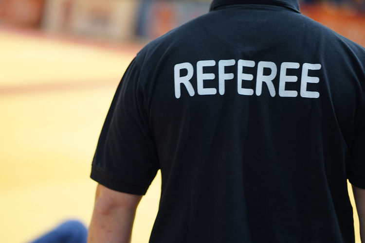 Rear view of man with referee text