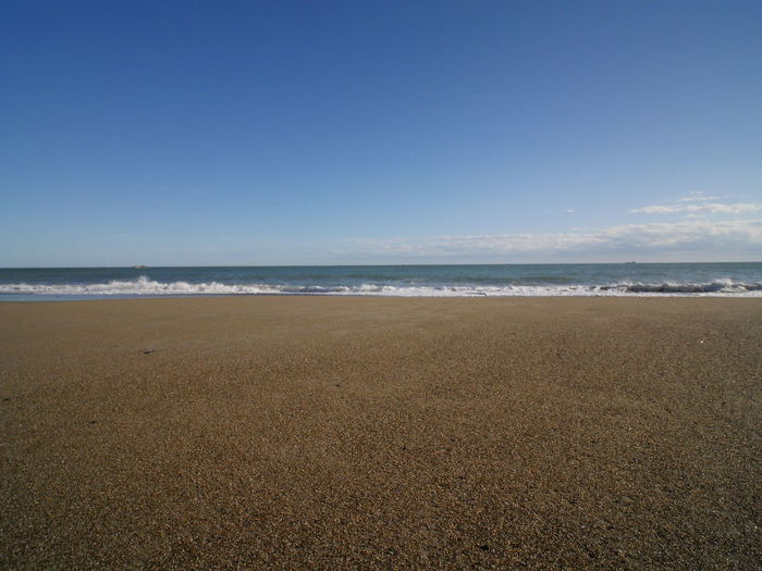 Scenic view of beach against clear sky