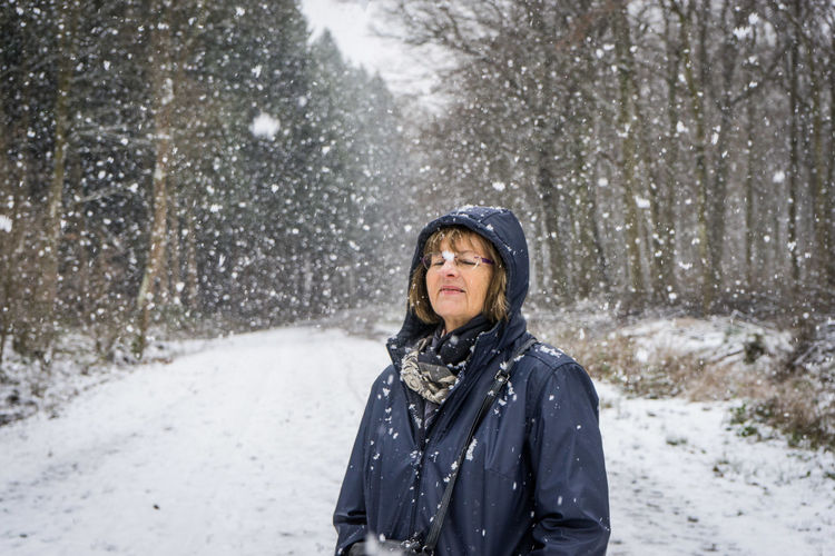 Portrait of woman in forest in winter