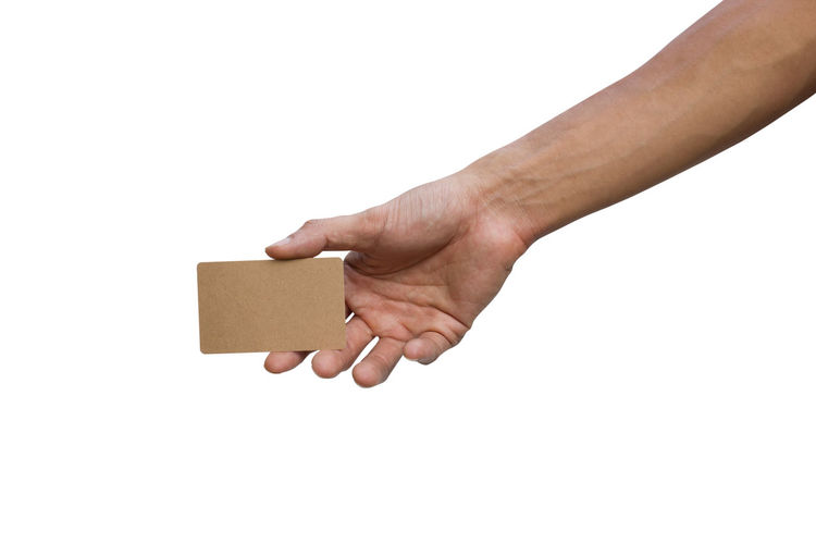 Cropped hand holding business card against white background
