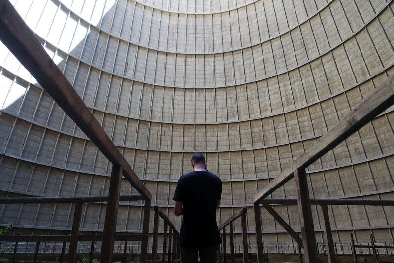 Man standing amidst railings against buildings