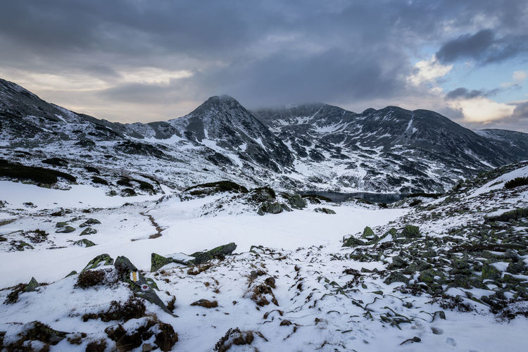 Scenic view of snow covered mountains against sky