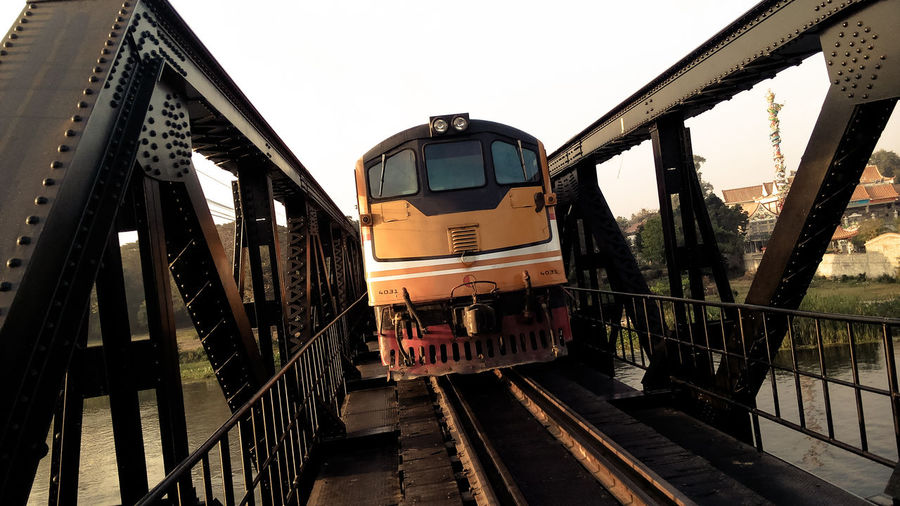 Train on bridge against sky