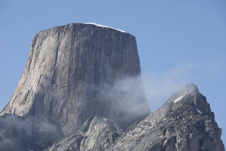 Cloud passes in front of iconic mountain, mount asgard, baffin island.