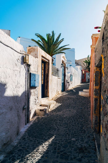 Empty alley by houses at santorini
