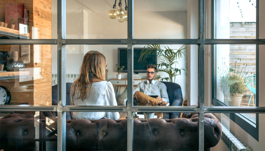 People sitting in glass window