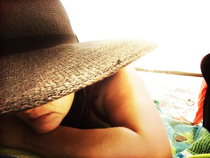 Low section of woman resting on beach