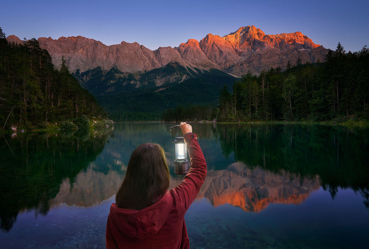 Rear view of woman looking at lake