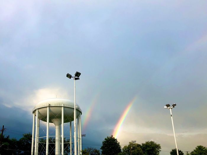 Low angle view of rainbow over street against sky