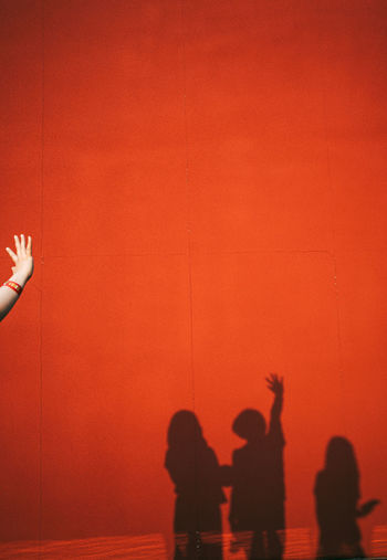 Shadow of people on red wall