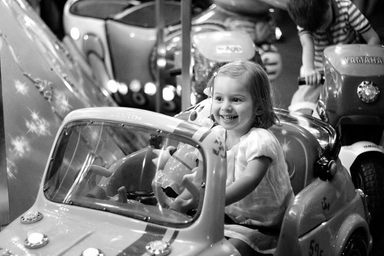 High angle view of happy girl enjoying in carousel at amusement park