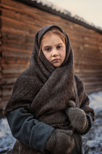 Portrait of girl wrapped with blanket