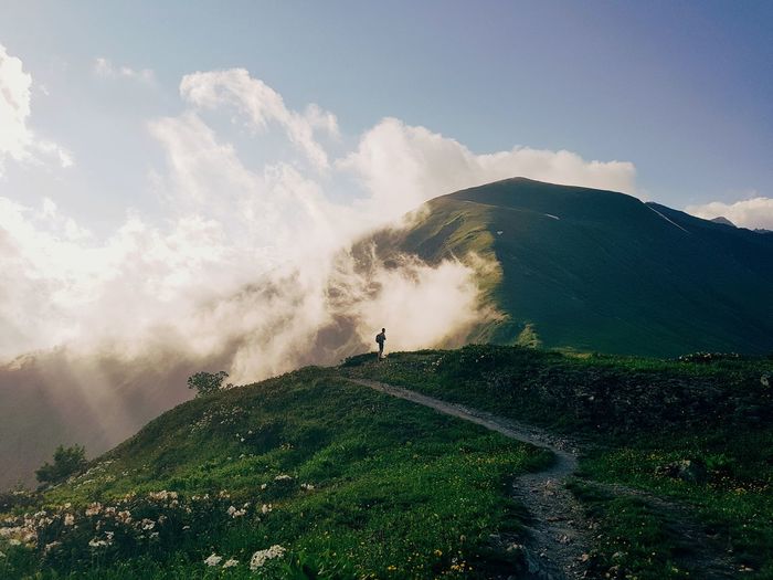 Man standing on mountain against sky