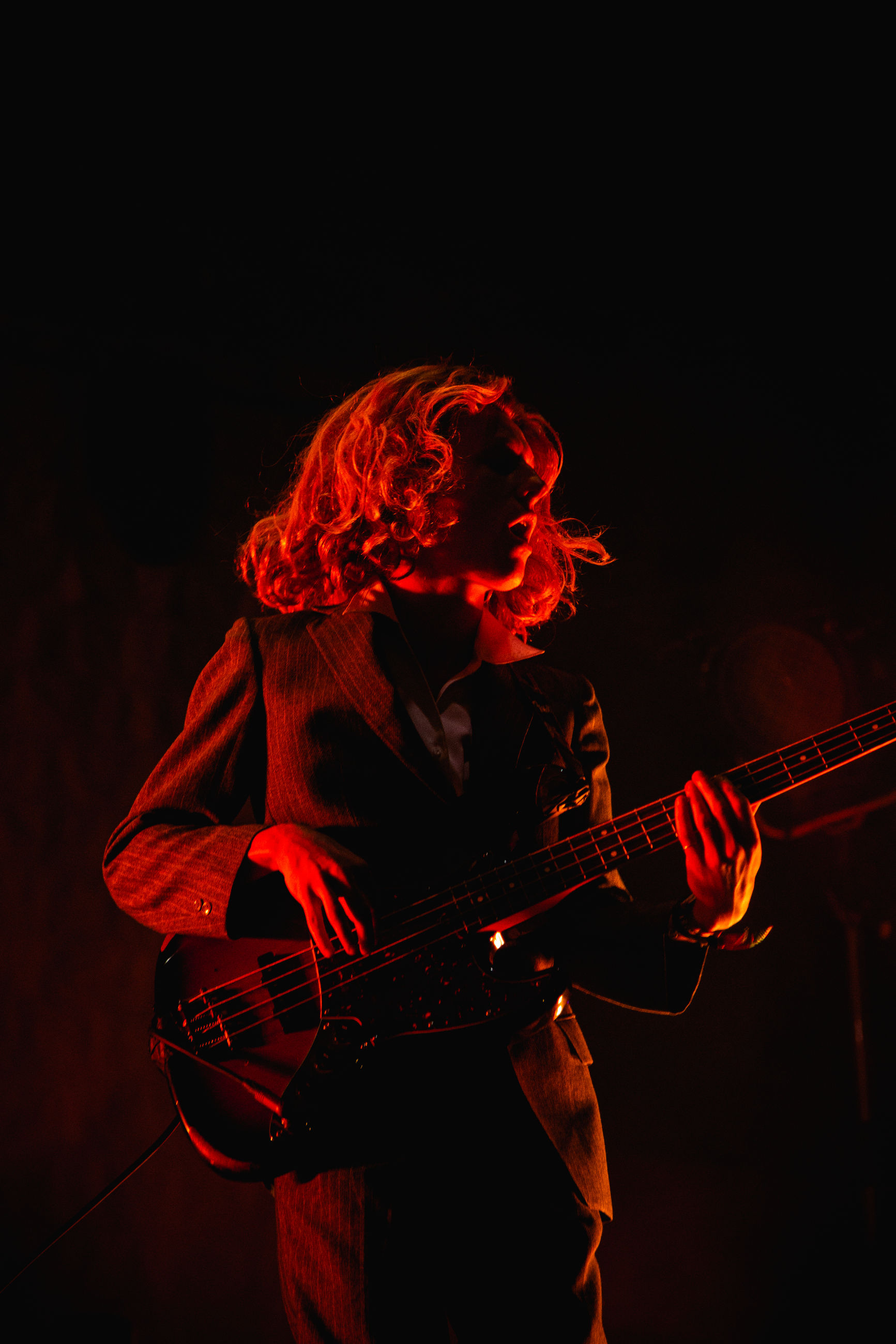 musical instrument, music, arts culture and entertainment, string instrument, playing, musical equipment, performance, guitar, artist, musician, one person, skill, real people, event, stage, stage - performance space, guitarist, night, holding, nightlife, concert, popular music concert, entertainment occupation, rock music, electric guitar, black background
