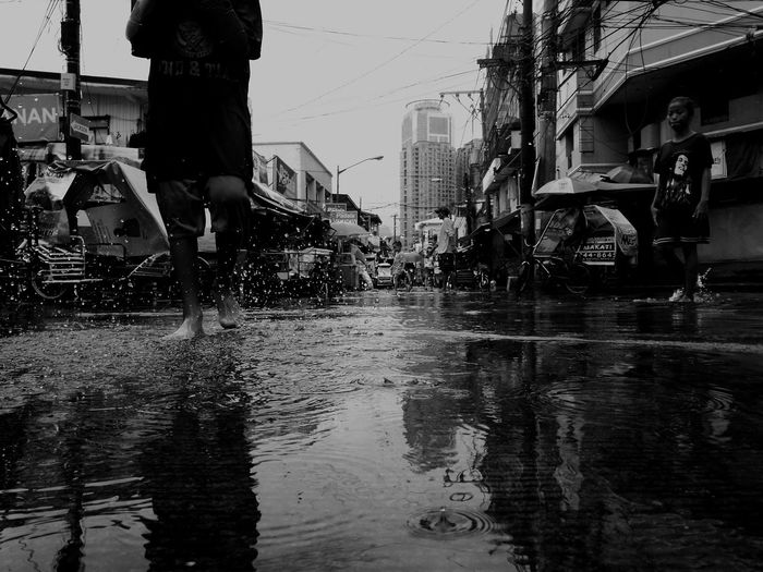 View of wet city street during rainy season