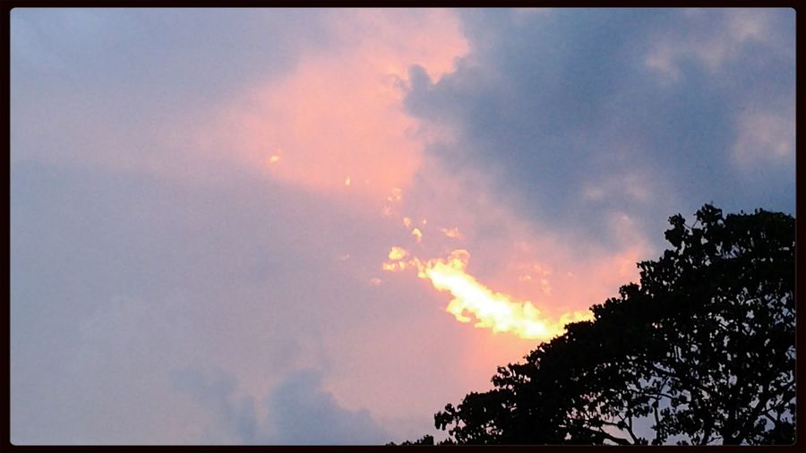 Low angle view of cloudy sky at sunset