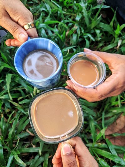 Cropped hand of woman and men holding tea which is called best therapeutic 