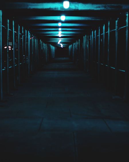Empty corridor in building at night