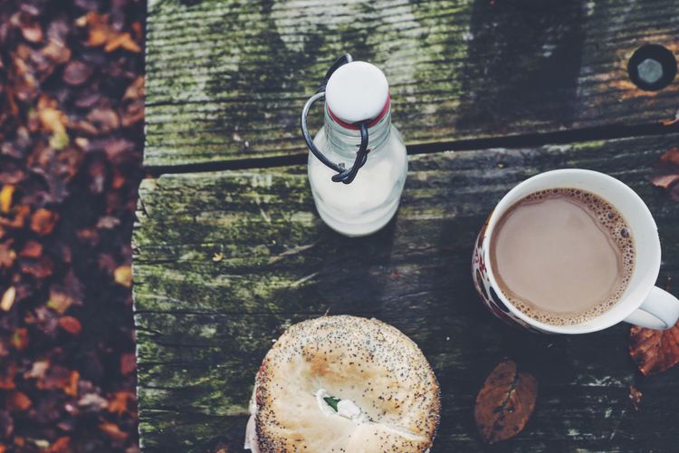 High angle view of bagel and coffee on table during autumn