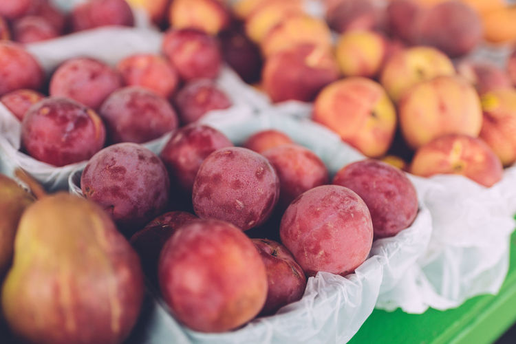 Close-up of plums for sale at market stall