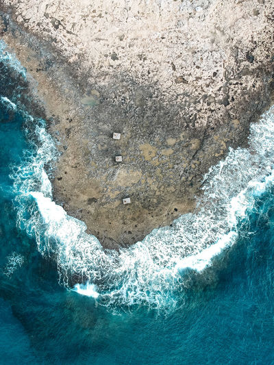 High angle view of rock formation and sea