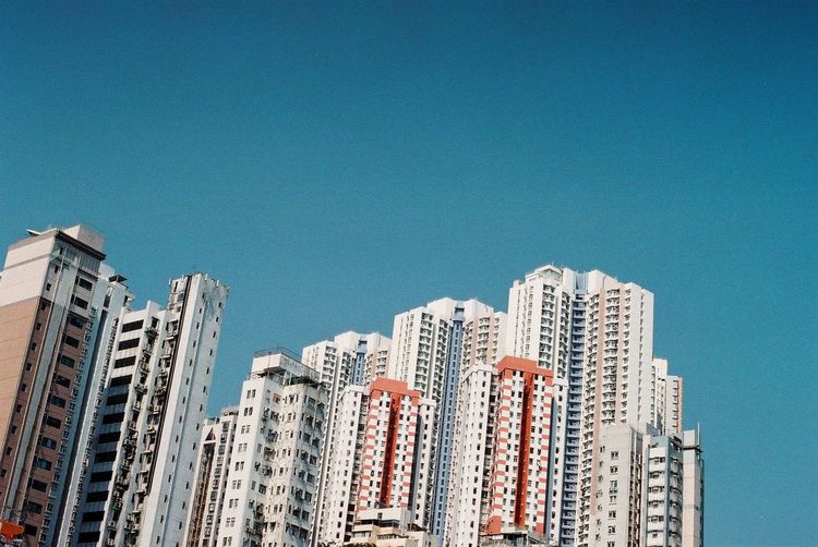 Low angle view of apartment skyscrapers against clear sky