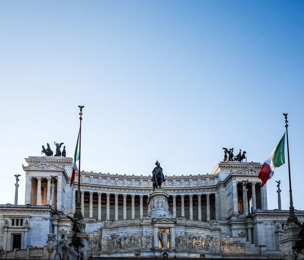 Italian flag by altare della patria against clear sky