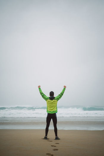 Rear view of man standing on beach