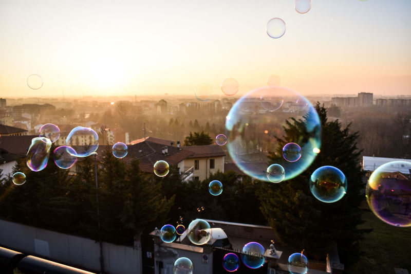 Bubbles against sky at sunset