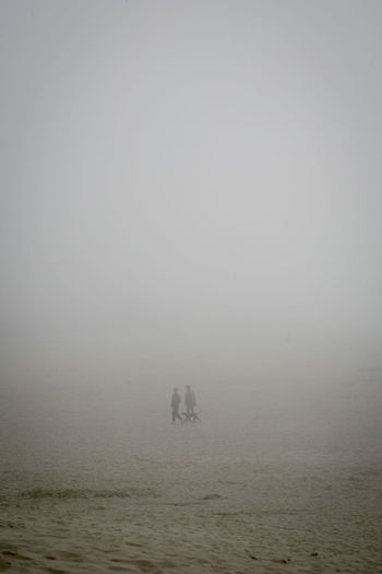 Scenic view of sea against sky during foggy winter