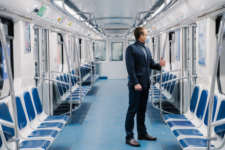 Businessman standing in empty train