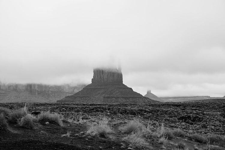 Scenic view of west and east mitten buttes during foggy weather
