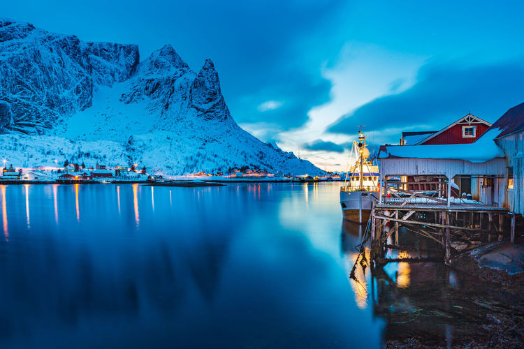 View of boat moored at harbor against mountain
