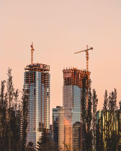 Modern buildings against clear sky during sunset