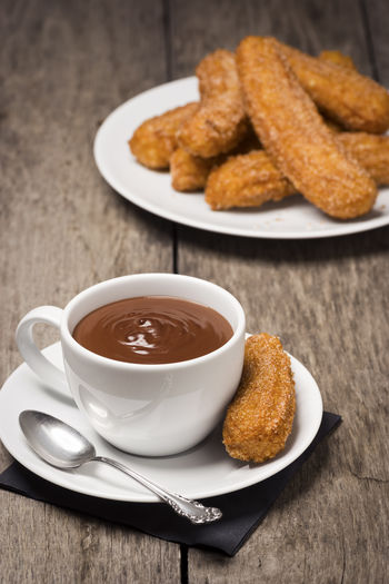 Close-up of churros and dip on table