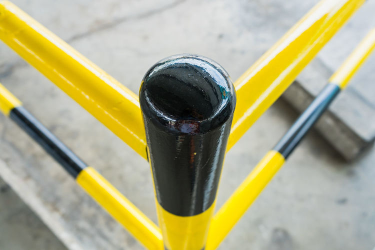 Motorcycle parking lot barrier with yellow and black.