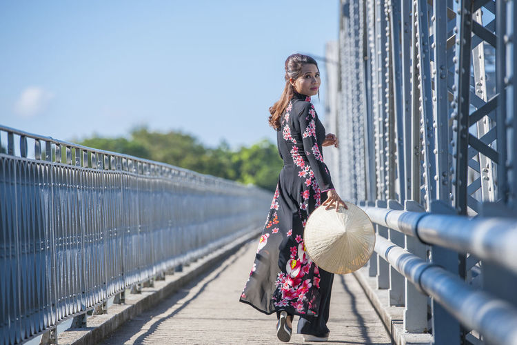 Woman walking on footbridge
