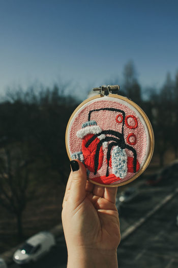 Close-up of hand holding hand embroidery piece