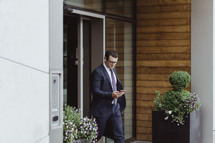 Entrepreneur using smart phone while walking in city