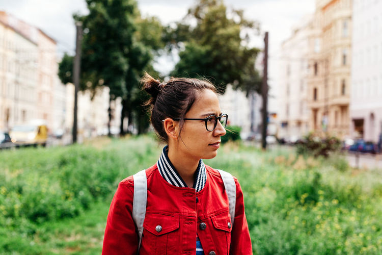 Young woman with eyeglasses looking away