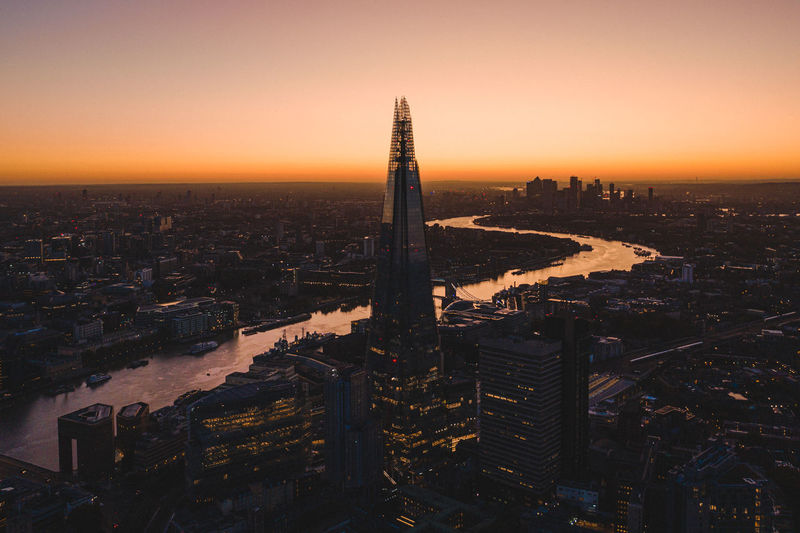 Shard london bridge amidst cityscape during sunset