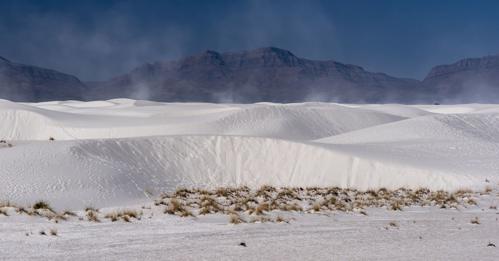 Scenic view of sand mountains against sky