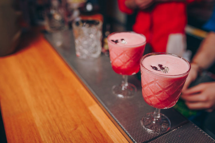 Close-up of drinks on table with people on background