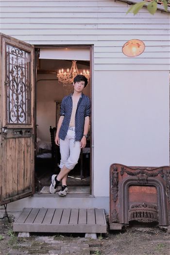 Teenage boy standing at doorway