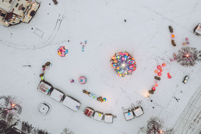 Directly above shot of christmas decorations and houses in snow