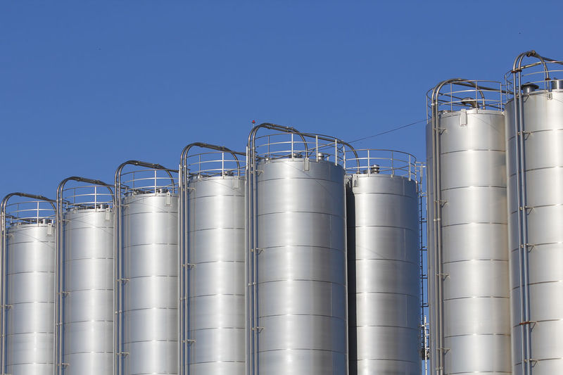 Low angle view of industry against sky