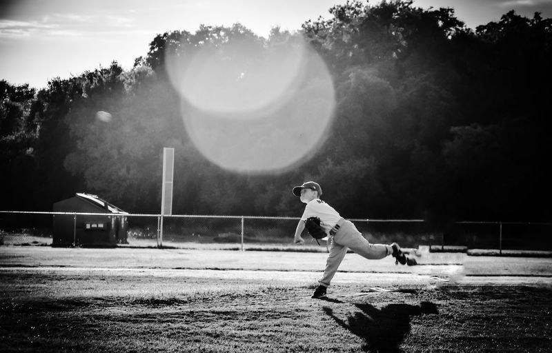 Boy playing baseball on field