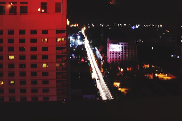 People walking in illuminated city at night