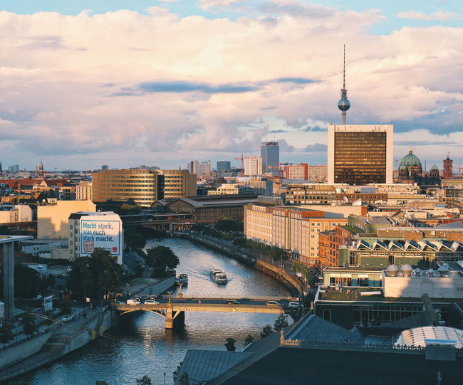 High angle view of spree river by fernsehturm amidst buildings in city