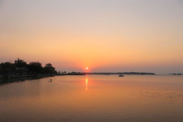 Scenic view of lake against sky during sunset
